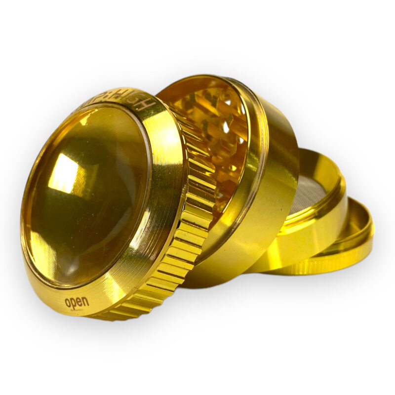 Złoty grinder ze szkłem powiększającym przekrój czterech części